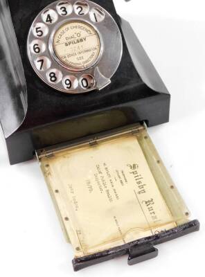 A 20thC black Bakelite telephone, with shaped receiver attached by a wire, with a articulated chrome front dial and drawer, 16cm W. - 2