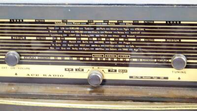 A mid 20thC ACE radiogram, in a rectangular cabinet, on turned legs with front tuning knops and grill speaker beneath, 82cm H, 49cm W, 33cm D. - 2