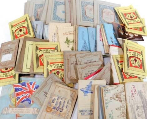 Various cigarette trade and other cards, albums, etc. to include Player & Sons, Hints On Association Football, Birds and Their Young, Wills, Military Uniforms Of The British Empire Overseas, various blank books, Sea Fishes, Dogs, etc. (a quantity)