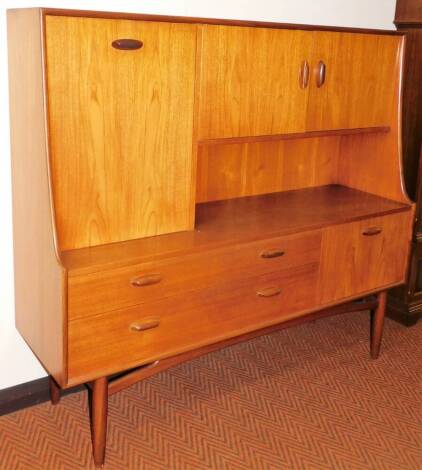 A vintage G-Plan style teak side cabinet, with fall and double cupboard to the top above two drawers and further cupboard, on square tapering legs, 135cm H, 151cm W, 48cm D. (unmarked)