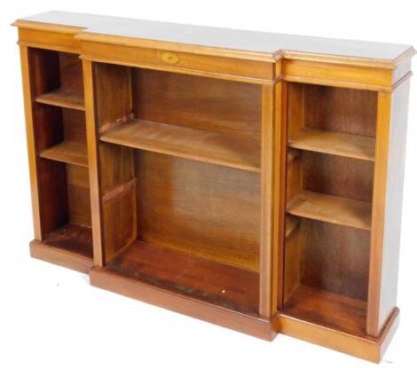 An Edwardian walnut mahogany and satinwood inlaid breakfront dwarf bookcase, with oval floral patera and open shelves on a block base, 92cm H, 128cm W, 26cm D.