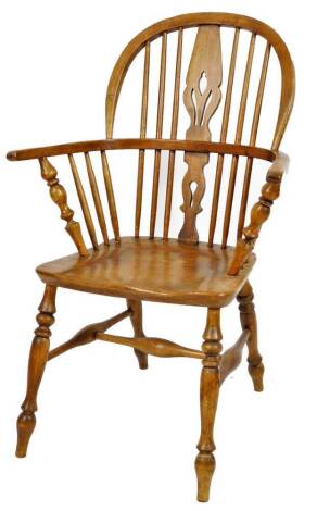 An oak and elm low back Windsor chair, with hoop top, pierced back splat, turned arm supports and turned legs joined by a H stretcher, 99cm H.