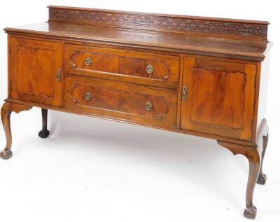 An Edwardian mahogany sideboard, with a blind fret gallery raised above two drawers flanked by panelled cupboards on cabriole legs terminating in claw and ball feet, 116cm H, 183cm W, 53cm D.