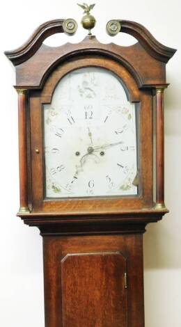 A 19thC oak longcase clock, with a broken swan neck pedimented hood surmounted by an eagle and urn finial above a canted long trunk door, on a block base with an arched 29cm Dia. Arabic dial with subsidiary second hand and date aperture, with painted flor