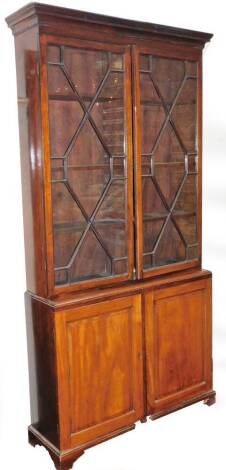 A 19thC mahogany library bookcase, with moulded cornice raised above a pair of astragal glazed doors and three shelves above a double cupboard beneath, on ogee bracket feet, 217cm H, 105cm W, 33cm D.