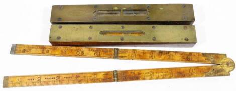 An early 20thC boxwood folding ruler, with metal mounts, numbered 1377, stamped John Rabone & Sons, Birmingham and two brass topped spirit levels. (3)
