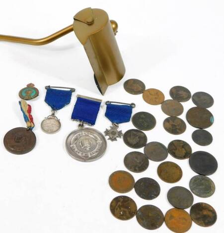 Various low denomination coins, medals and a light with shade, with electrical fitting.