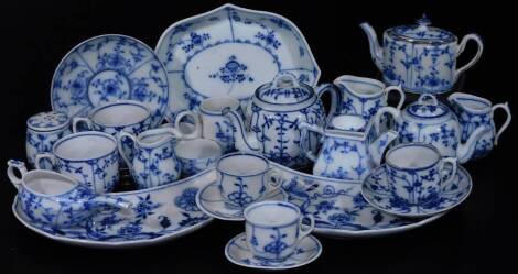 A matched continental blue and white porcelain part service, each piece similarly decorated with flowers to include crescent shaped dishes, 23cm H, miniature teapot, coffee pot, pap boat, various other items, etc, various marks beneath to include T, II, l