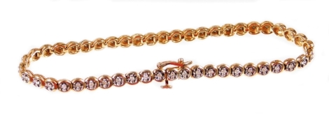 A tennis bracelet, with circular links, set with white stones with plain clasp marked 9k, 20cm L, 8.5g all in.