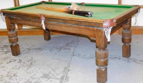 An early 20thC Riley oak framed slate bed quarter snooker table, with baize lining and associated cues, scoreboard and balls, 80cm H, 194cm W, 102cm D.