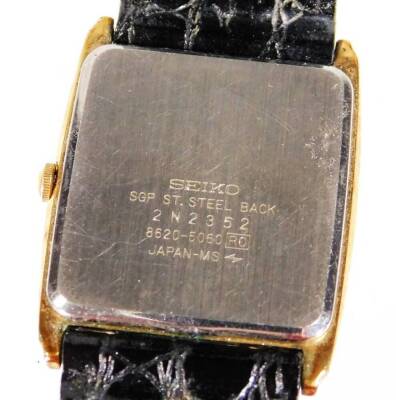 A gentleman's Seiko quartz wristwatch, with black bracelet, 3cm oblong dial with baton pointers and numerals on a yellow ground, and a silver plated watch chain. (2) - 3