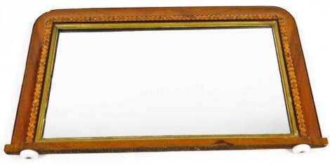 A late 19thC parquetry over mantel mirror, the rounded top inlaid with various sections with a plain glass, 41cm x 69cm .