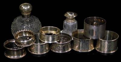 Various napkin rings, to include a late Victorian silver circular example, partially chased, Sheffield 1897, 5cm Dia. various others, 5½oz and two cut glass perfume bottles. (a quantity)