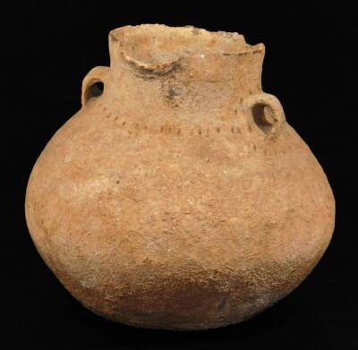 A terracotta vessel, probably Roman, of circular form, with hand moulded handles, 23cm H.