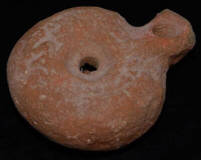 A hand thrown terracotta vessel, probably early terracotta, 11cm Dia., various other Roman bowls, a bulbous vase and a Roman style oil lamp. (4) - 11