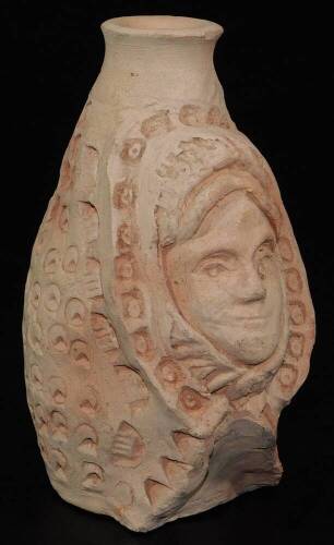 A terracotta face mask vase, heavily decorated, probably Roman, 15cm H.