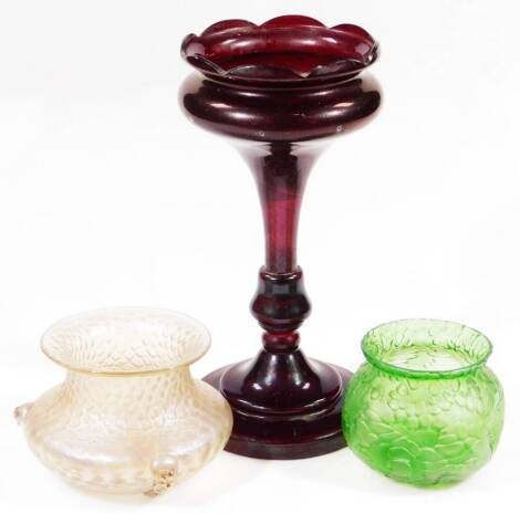 An early 20thC Loetz style glass bowl, of textured form with elaborate scroll legs, 14cm Dia. a 19thC single ruby glass lustre and a further Loetz style globular vase in green. (3)
