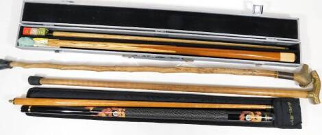 A horn topped walking stick, another with shaped brass handle, 86cm H, a two piece snooker cue and another two piece Power Glide snooker cue with accessories in fitted case. (a quantity)