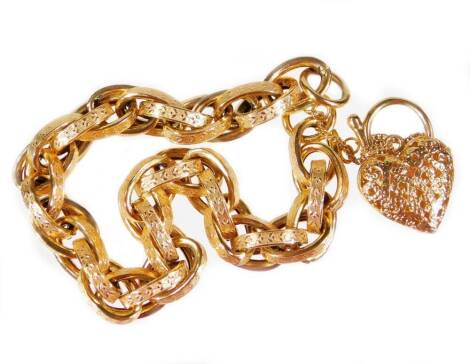 A 9ct gold curb link bracelet, with heart shaped padlock and safety chain, with multi link layered curb link, with design of leaves, with a pierced heart shaped padlock, makers stamps Linda, 16cm long overall, 19.1g all in.