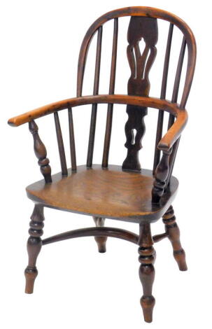 A mid 19thC yew and elm child's Windsor armchair, with a pierced splat, solid seat, on turned legs with crinoline stretcher.