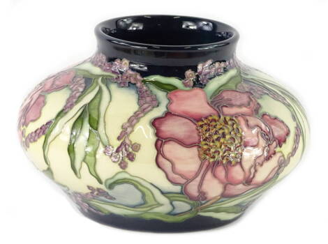 A Moorcroft limited edition squat baluster shaped pottery vase, decorated with large pink flowers, trailing flowers, leaves etc., various stamps to underside to include Goodwin, initials A.B., copyright 2002, No. 142/300, 18cm D. (boxed)