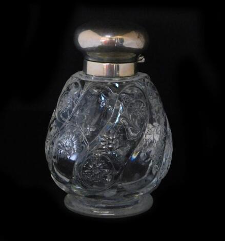 An early 20thC Thomas Webb & Son rock crystal scent bottle, of footed spiral fluted form, engraved with flowers and scrolling foliate tendrils, with silver mount and hinged lid, Thomas Webb & Son, London 1901, 14.5cm H.