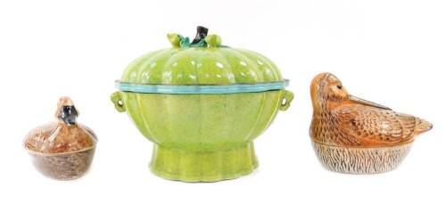 Two Michel Caugant tureens, modelled as a snipe and a duck, 17.5cm and 16cm W respectively, together with a French majolica type food warming bowl, liner and cover, of twin handled fluted form, with a fruit branch and leaves knop, 24cm W. (3)