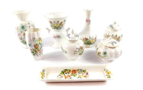 A group of Aynsley porcelain decorated in the Wild Tudor pattern, comprising four vases and three jars and covers, together with a pin dish decorated in the Cottage Garden pattern. (8)