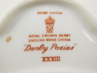 Royal Crown Derby porcelain decorated in the Derby Posies pattern, including cream jug and sugar bowl, trinket dishes, spill vases, cups and saucers. (qty) - 3