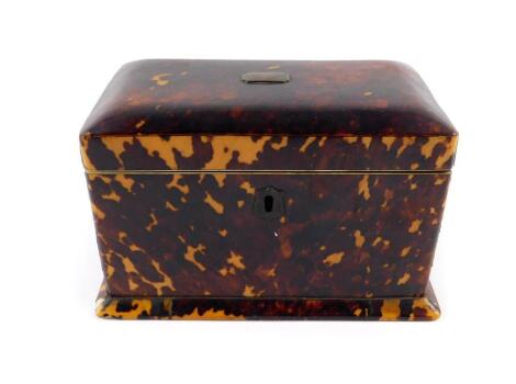 A Georgian blonde tortoiseshell tea caddy, of rectangular form with ivory stringing and brass plate to the hinge lid, opening to reveal twin compartments, raised on a plinth base, 11cm H, 18.5cm W, 11cm D. (A/F)