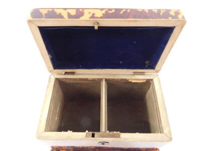 A Georgian blonde tortoiseshell tea caddy, of rectangular form with ivory stringing and brass plate to the hinge lid, opening to reveal twin compartments, raised on a plinth base, 11cm H, 18.5cm W, 11cm D. (A/F) - 4