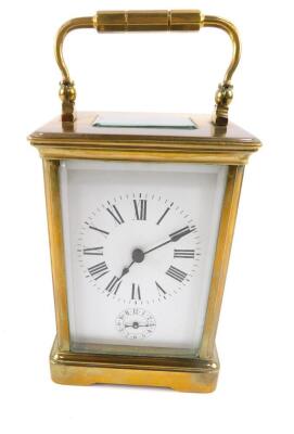 A brass cased alarm carriage clock, rectangular enamel dial bearing Roman numerals, subsidiary alarm dial, barrel movement, the case of conventional form, with key, 15cm H, 9cm W, 8cm D.