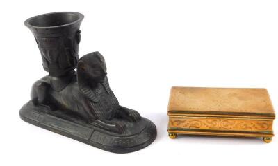 A Victorian bronze match striker and holder, modelled as a recumbent sphinx with a container on its back, cast with Pharaoh's masks, marked KR to base, 15.5cm W, together with a Victorian brass match casket, with striker, with engraved foliage decoration,