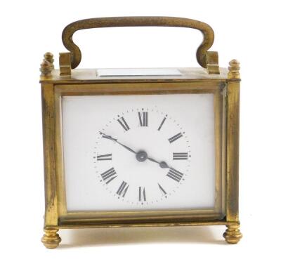 A French rectangular brass cased carriage clock, inset bevel glass, enamel dial bearing Roman numerals, the case of plain form raised on turn feet, with key, 8cm H, 9cm W, 5.5cm D.