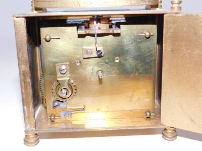 A French rectangular brass cased carriage clock, inset bevel glass, enamel dial bearing Roman numerals, the case of plain form raised on turn feet, with key, 8cm H, 9cm W, 5.5cm D. - 4