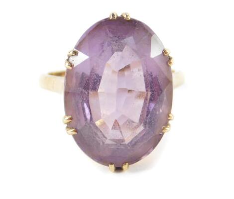 An amethyst solitaire ring, high claw set in yellow metal, stamped 9ct, approx 14cts, size Q, 7.2g.