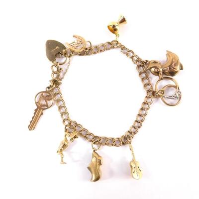 A 9ct gold double link charm bracelet, on a heart shaped padlock clasp with safety chain and nine charms as fitted, 15.8g.