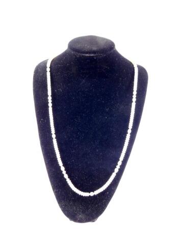 A freshwater pearl necklace, set with yellow metal beads at intervals, approx 77cm L.