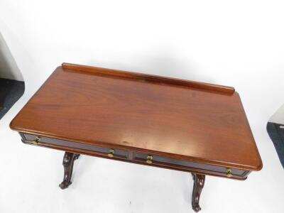 A Victorian mahogany side table, with two frieze drawers raised on turned fluted columns over cabriole legs, on brass casters, united by a turned stretcher 80cm H, 122cm W, 55cm D. - 2