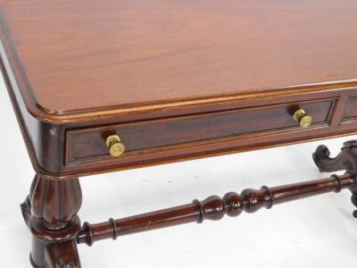 A Victorian mahogany side table, with two frieze drawers raised on turned fluted columns over cabriole legs, on brass casters, united by a turned stretcher 80cm H, 122cm W, 55cm D. - 3