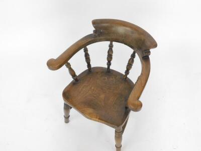 A 19thC oak and elm child's bow chair, with solid saddle seat, raised on ring turned legs united by a H frame stretcher. - 2