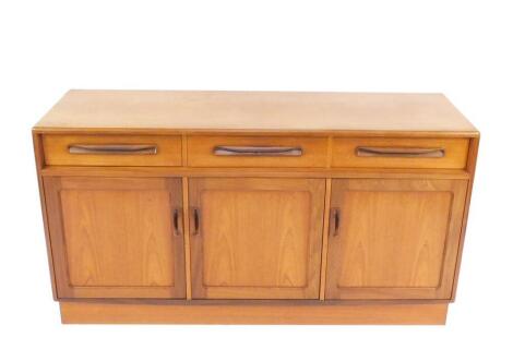 A G-Plan teak sideboard, with three drawers over three cupboard doors, raised on a plinth base, 75cm H, 142cm W, 44.5cm D.