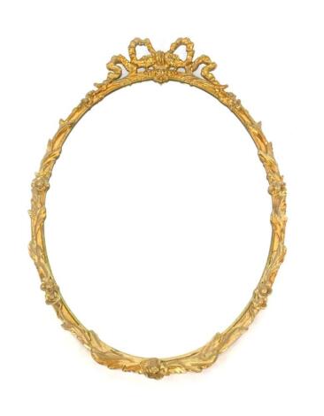 A rococo style gilt oval wall mirror, inset bevelled glass, with bow surmount and floral and foliate moulding, 102cm H x 62cm W.