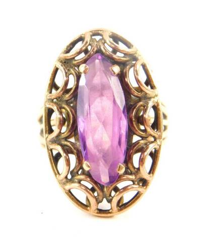 An amethyst solitaire ring, marquise cut in a yellow metal oval open work setting, and open work shank, size O, 8.4g.