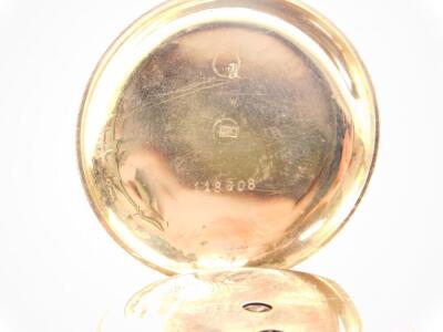 A lady's 14ct gold cased pocket watch, open faced, key wind, enamel dial bearing Roman numerals, movement by Thos. Russell & Sons, Liverpool., the case with engraved floral and foliate decoration, shield reserve, 40.8g all in. (AF) - 2