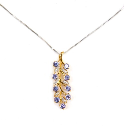 A tanzanite and diamond floral leaf pendant, on a silver neck chain.