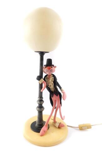 A Linea Zero Italian Pink Panther table lamp, modelled standing leaning against a lamp post, on a circular cream base, 52cm H.