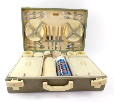 A mid 20thC Brexton four place picnic set, including plastic plates and dishes, containers, vacuum flasks and condiments, case 49cm W.