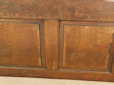 A 19thC oak settle, with a four panelled back, scrolling arms, with over stuffed seat, raised on turned legs, 183cm W. - 4