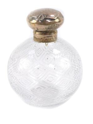 An Edward VII cut glass scent bottle and stopper, with fluted geometric decoration, silver mount and lid, monogram engraved, Birmingham 1906.